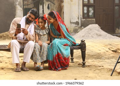 Indian Happy Rural Family Using Phone In Village