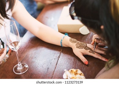 Indian Henna Tattoo Artist Drawing The Uniqueness Line Art On The Women Hand