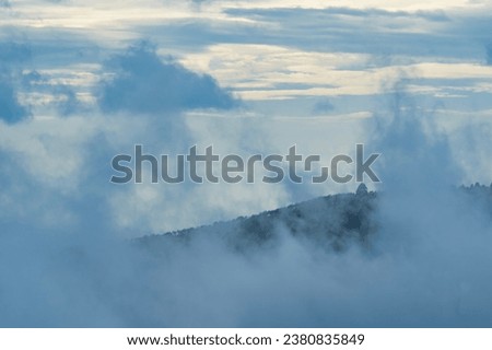 Indian hill station aerial view and covered with fog during the evening time with Mountain visible. Indian hills station tourist spot. Tamilnadu hills and tourism.