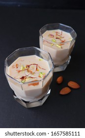 Indian Holi Or Kojagiri Festival Drink Thandai Or Masala Milk. It Is An Indian Cold Drink Prepared With A Mixture Of Milk, Dry Fruits & Sugar. Garnished With Almonds, Pistachio & Saffron. Copy Space.