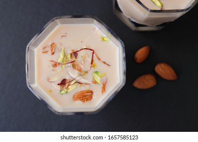 Indian Holi Or Kojagiri Festival Drink Thandai Or Masala Milk. It Is An Indian Cold Drink Prepared With A Mixture Of Milk, Dry Fruits & Sugar. Garnished With Almonds, Pistachio & Saffron. Copy Space.