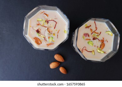 Indian Holi Or Kojagiri Festival Drink Thandai Or Masala Milk. It Is An Indian Cold Drink Prepared With A Mixture Of Milk, Dry Fruits & Sugar. Garnished With Almonds, Pistachio & Saffron. Copy Space.