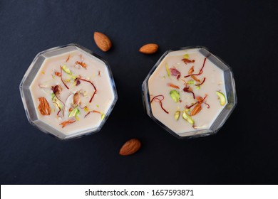 Indian Holi Or Kojagiri Festival Drink Thandai Or Masala Milk. It Is An Indian Cold Drink Prepared With A Mixture Of Milk, Dry Fruits & Sugar. Garnished With Almonds, Pistachio & Saffron. Copy Space.