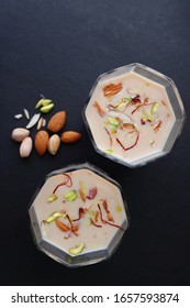 Indian Holi Or Kojagiri Festival Drink Thandai Or Masala Milk. It Is An Indian Cold Drink Prepared With A Mixture Of Milk, Dry Fruits & Sugar. Garnished With Almonds, Pistachio & Saffron. Copy Space.