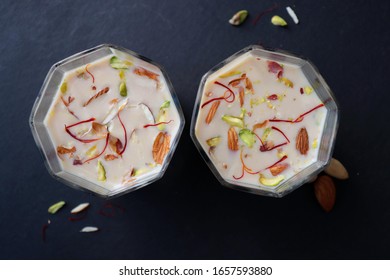 Indian Holi Or Kojagiri Festival Drink Thandai Or Masala Milk. It Is An Indian Cold Drink Prepared With A Mixture Of Milk, Dry Fruits & Sugar. Garnished With Almonds, Pistachio & Saffron. Copy Space.