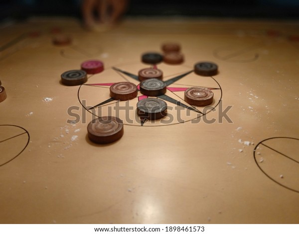 indian indoor game carom carrom board with wooden\
acrylic discs