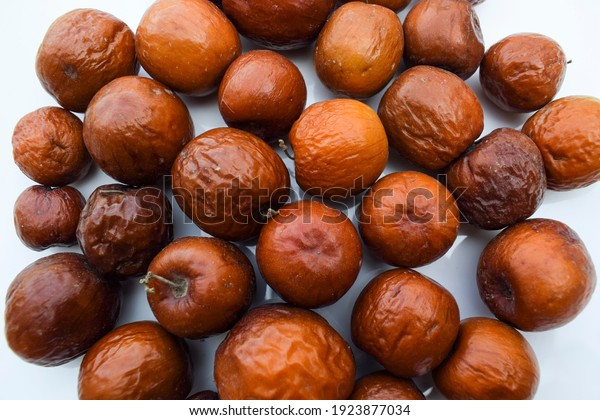 Indian jujube fruit, grown in the wilds or jungle\
in India, Pakistan, bangladesh Asian. Closeup of India fruit orange\
red maroon brown color.