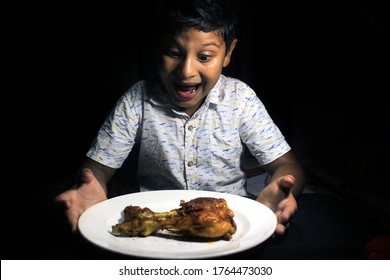 Indian Kid Eating Fried Chicken Drumstick. Child Having A Chicken Drumstick To Eat. Child With Yummy Chicken Roast.