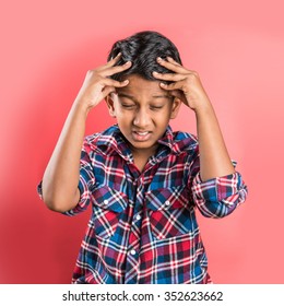 Indian Kid And Headache Or Cephalalgia, Standing Isolated Over Yellow Background