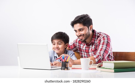 Indian kid studying online, attending school via e-learning with father - Powered by Shutterstock