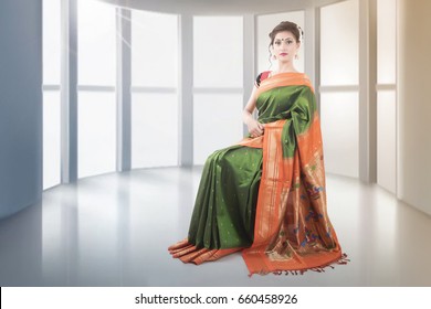 Indian Lady In Saree Sitting On Chair