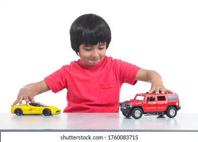 Indian Little Boy Plays With Toy Car Photo