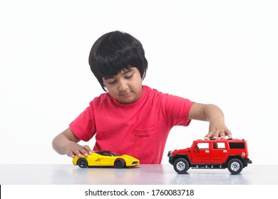 Indian Little Boy Plays With Toy Car Photo