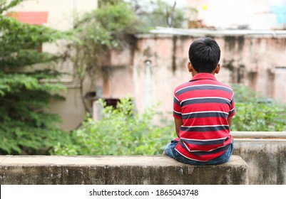 Indian Little boy sitting lonely	