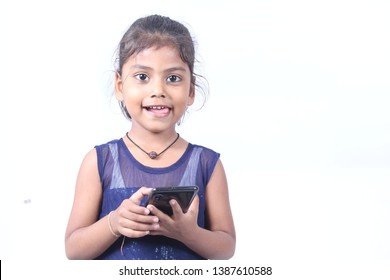 Indian little cute girl playing and posing on white background 