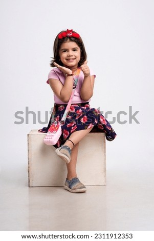 Indian little girl giving expression on white background.
