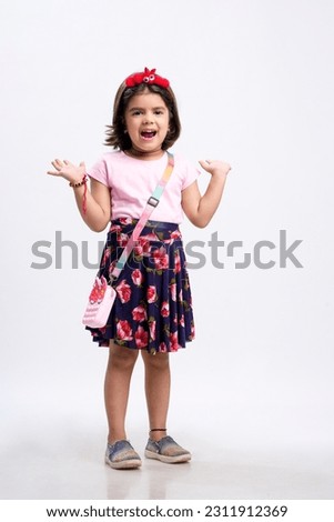 Indian little girl giving expression on white background.