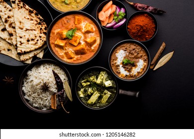 Indian Lunch / Dinner main course food in group includes Paneer Butter Masala, Dal Makhani, Palak Paneer, Roti, Rice etc, Selective focus
