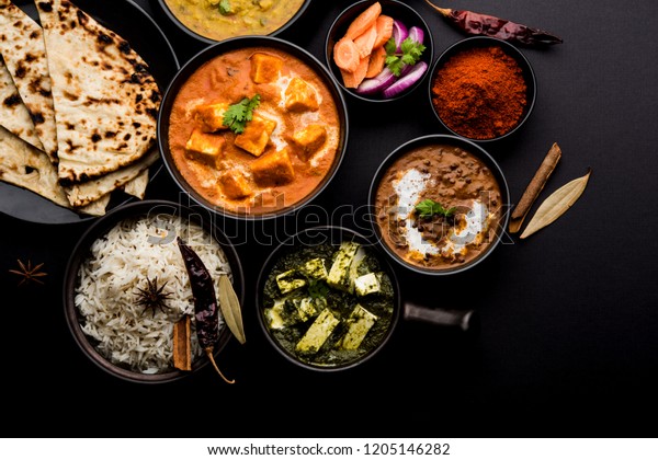 Indian Lunch / Dinner main course food in group\
includes Paneer Butter Masala, Dal Makhani, Palak Paneer, Roti,\
Rice etc, Selective\
focus