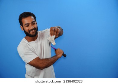 Indian Male Badminton Player On Blue Background.