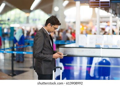 Indian Male Checking Airport Schedule