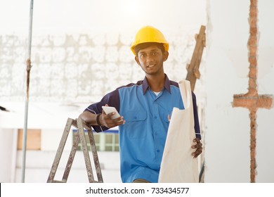 Indian Male Construction Worker Using Phone