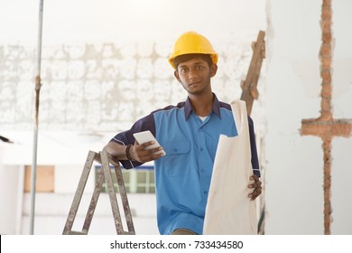 Indian Male Construction Worker Using Phone