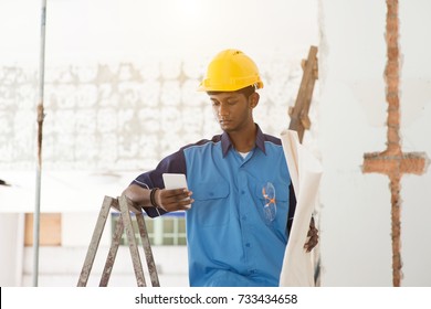 Indian Male Construction Worker Using Phone