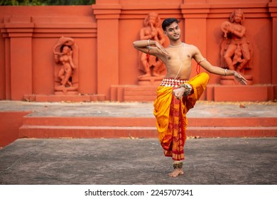 Indian male dancer in the posture of Indian dance in front of sculptures, Odisha. Indian dance odissi - Shutterstock ID 2245707341
