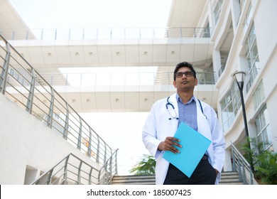 indian male doctor with hospital background
