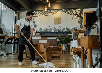 Indian male employee sit and resting after a long day at work. Small business owner coffee shop tired after mopping the floor, waitres secretly fell asleep after working hard. Restaurant owner concept - Powered by Shutterstock