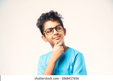 Indian Male Kid Thinking Against White Background, Asian Little Boy Wears Spectacles And Finding Solution For Something