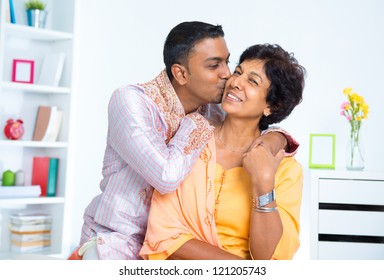 Indian male kissing his mother, living lifestyle at home