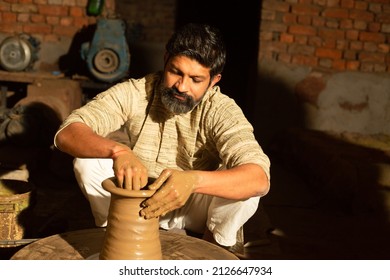 Indian Male Pottery Maker Building A Clay Pot, Beard Man Worker Or Labour Working.skill India Concept.