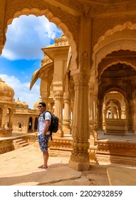 An Indian Male Solo Traveler  at the Ruined Cenotaphs of Bada Bagh, also called Grand Garden at Jaisalmer in the Indian state of Rajasthan.    - Shutterstock ID 2202932859