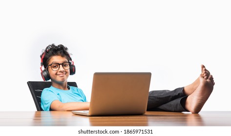 Indian Male Syudent Or Kid Studying Online Using Laptop. Asian Child Attending Online School Using Computer