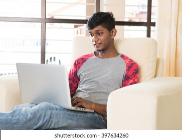 indian male teenager using laptop