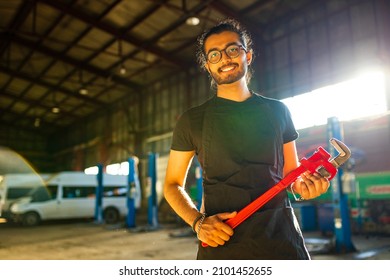 Indian Man Auto Mechanic Working Indoors In Car Shop