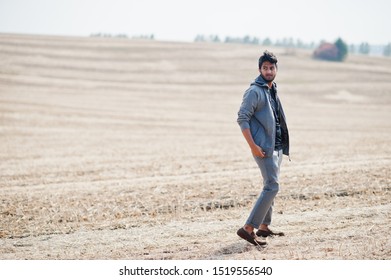 Indian man at casual wear posed at field alone.