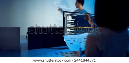Indian man developer presentation about coding software data with devops team at night in office