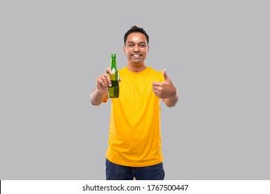 Indian Man Holding At Beer From Beer Bottle Showing Thumb Up Isolated.