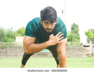 Indian man making push ups in open ground