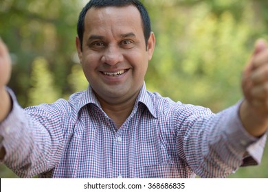 Indian Man In Park Taking Selfie