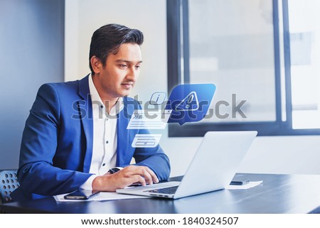 Indian man receiving alert notification in financial fraud protection software on his computer