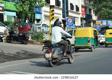 Indian Man Riding Scooter On Road. Location: New Delhi, India, Date 02-02-2022