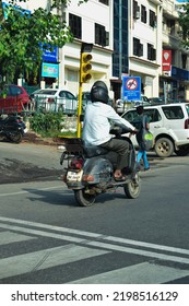 Indian Man Riding Scooter On Road. Location: New Delhi, India, Date 02-02-2022