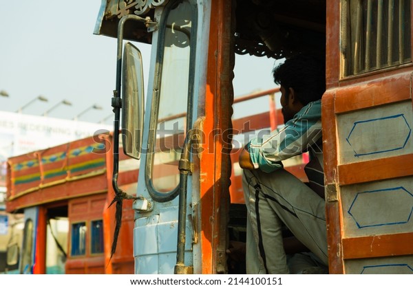 Indian man sitting in a\
truck in traffic