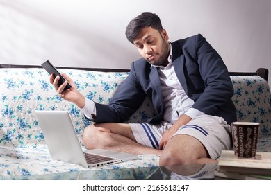 Indian Man Sleeping On Couch While Working On Laptop