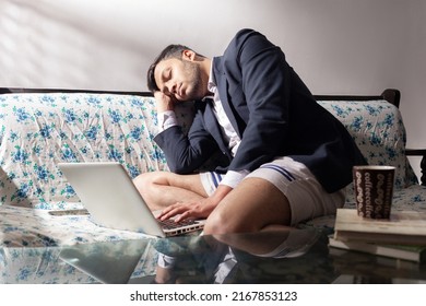 Indian Man Sleeping On Sofa After Overworked At Home Office