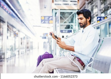 Indian Man Using His Phone In Airport Terminal